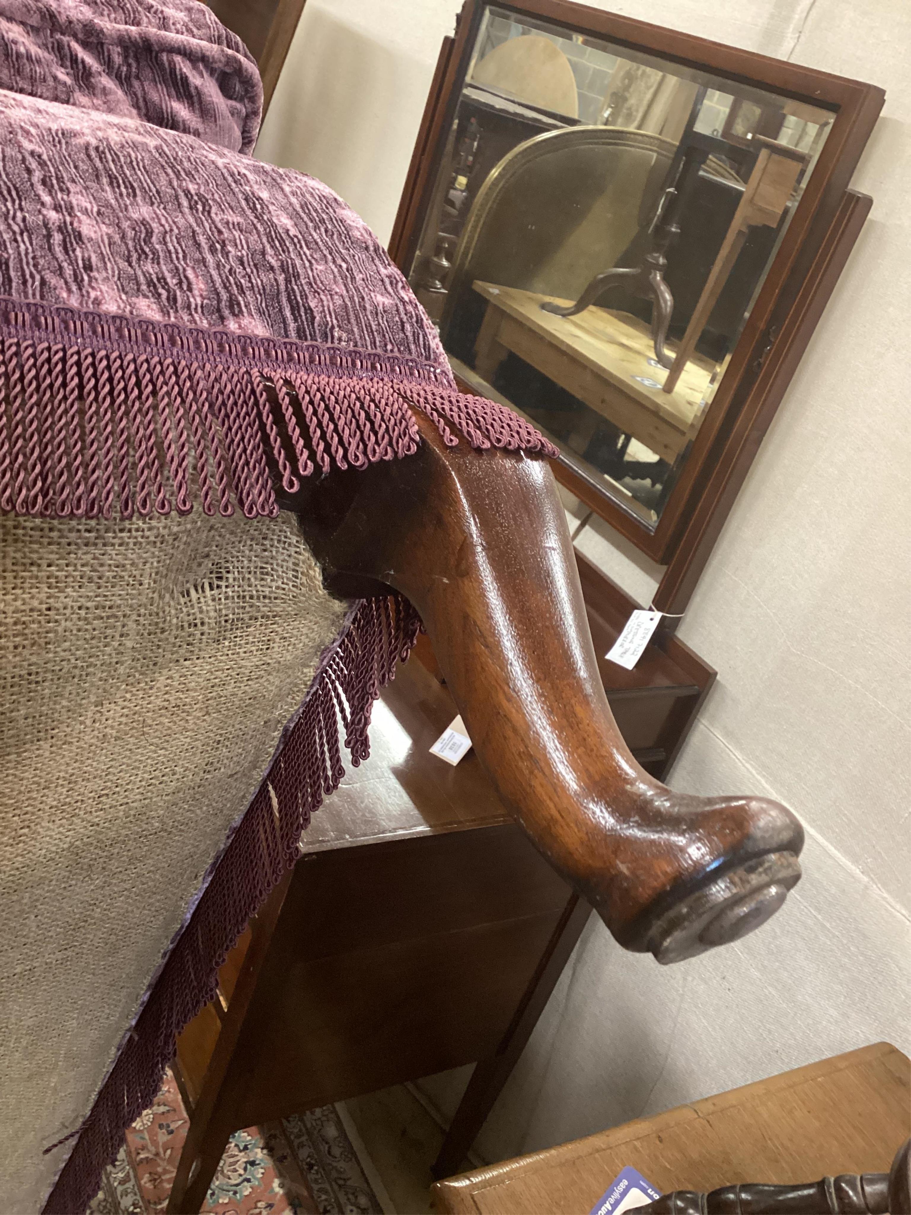 An early 20th century day bed, re-upholstered in contemporary buttoned purple fabric, width 160cm, depth 67cm, height 84cm. Condition - good